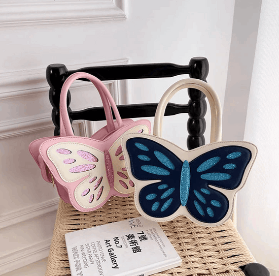 Sparkling Butterfly Handbag in pink and white and white and blue propped up against a chair