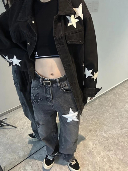 A downwards view of a model wearing the Stargaze Street Jeans in black gray.