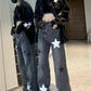 Model wearing the Stargaze Street Jeans in black gray with their reflection showing in a full-length mirror.