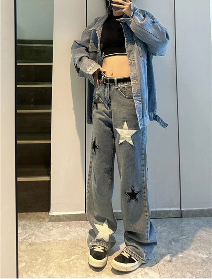 Model taking a picture in a mirror while wearing the blue Stargaze Street Jeans.