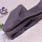 Folded pair of the Starlight Shimmer Tights in gray with silver shimmer displayed on a white faux-fur surface.