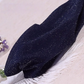 Folded pair of the Starlight Shimmer Tights in navy blue with silver shimmer displayed on a white faux-fur surface.