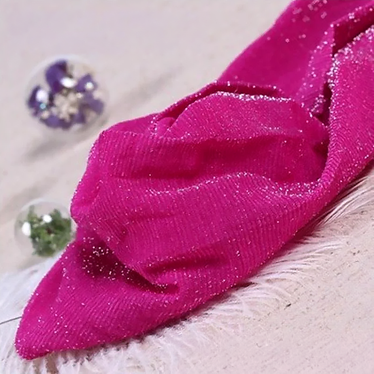 Folded pair of the Starlight Shimmer Tights in rose red with silver shimmer displayed on a white faux-fur surface.