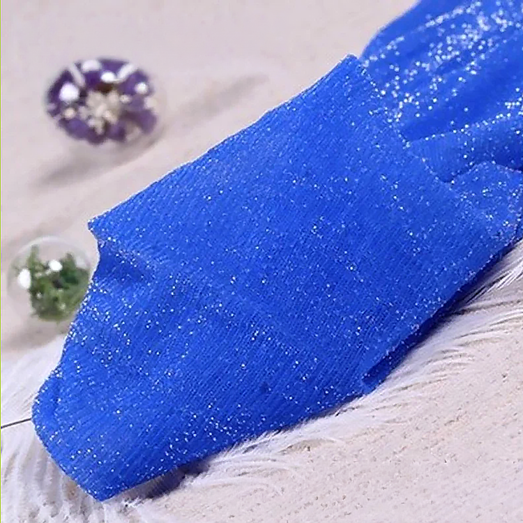 Folded pair of the Starlight Shimmer Tights in royal blue with silver shimmer displayed on a white faux-fur surface.