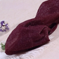 Folded pair of the Starlight Shimmer Tights in wine red with silver shimmer displayed on a white faux-fur surface.