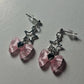 Close-up angled view of the Starlit Dreams Bow Earrings showing the delicate bow and star detail.