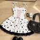Close-up of the Starry-Eyed Fantasy Dress bodice showing the black star print on structured white fabric, pink corset-style lace-up front, and black lace trim