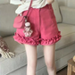 Model wearing hot pink Sugar Swirl Ruffle Shorts with ruffle hem and crossbody bag