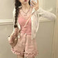 Angled front view of light pink Sugar Swirl Ruffle Shorts with ruffle hem detail