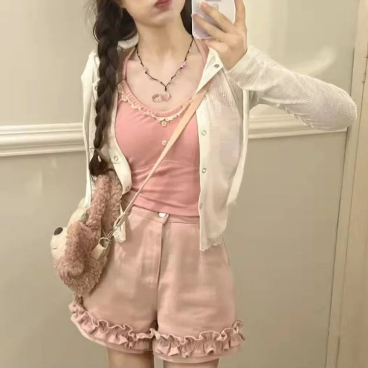 Angled front view of light pink Sugar Swirl Ruffle Shorts with ruffle hem detail