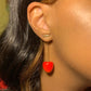 Close-up of model wearing vibrant red Sweet Cherry Earrings
