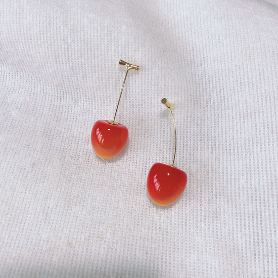 Vibrant red, small Sweet Cherry Earrings displayed on a white gauze-like background