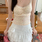 Model wearing apricot Sweet Flower Crop Top with pink floral pattern, paired with white lace skirt.