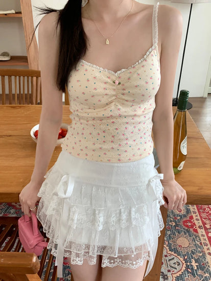 Model wearing apricot Sweet Flower Crop Top with pink floral pattern, paired with white lace skirt.