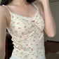 Side angle of Sweet Flower Crop Top in cream with multicolor floral details worn by model indoors.