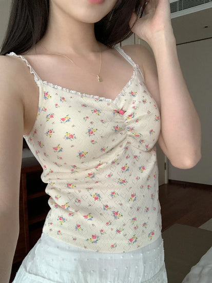 Side angle of Sweet Flower Crop Top in cream with multicolor floral details worn by model indoors.