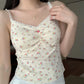 Model wearing cream Sweet Flower Crop Top with multicolor floral print and white skirt.