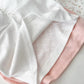 Flatlay of Sweet Flower Crop Tops in white and pink heart knit designs with soft texture.
