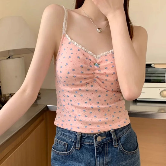 Sweet Flower Crop Top in pink with blue floral print and white lace trim being worn by a model in a kitchen setting.