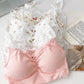 Stacked Sweet Flower Crop Tops in floral and heart prints with lace trim, styled beside pearls and a book.
