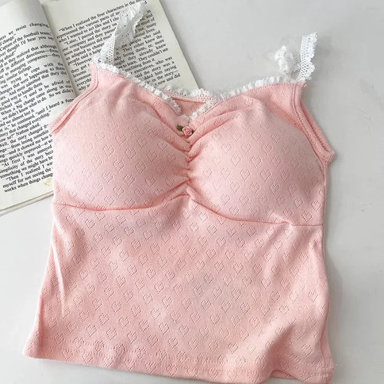 Pink Sweet Flower Crop Top laid flat next to open book, showcasing soft heart pattern and lace neckline.
