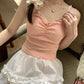 Close-up of pink Sweet Flower Crop Top worn by model, showing lace trim and mini flower detail.
