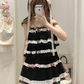 Model wearing the black and pink Sweet Love Lace Bow Skort with a matching layered top.