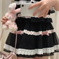 Close-up photo of a model wearing the black and pink Sweet Love Lace Bow Skort.