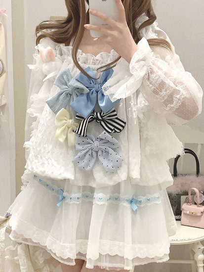 Model wearing the white and blue Sweet Love Lace Bow Skort styled with a top with multiple bows.