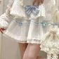 Front view of the white and blue Sweet Love Lace Bow Skort, featuring layered mesh, heart lace trim, and blue bow and ribbon accents.
