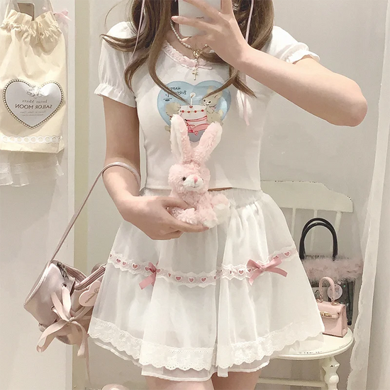 Model styling the white and pink Sweet Love Lace Bow Skort while holding a plush bunny.
