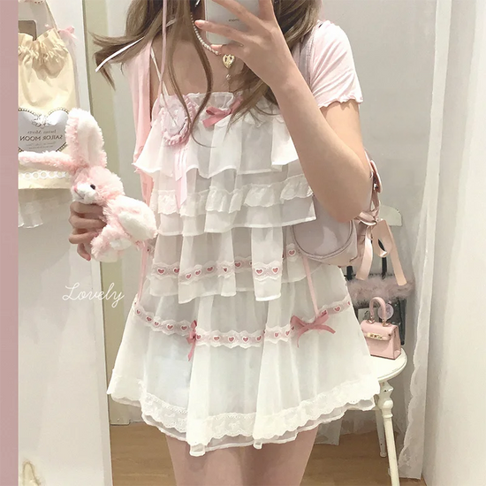 Model wearing the white and pink Sweet Love Lace Bow Skort with a matching layered top.