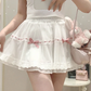 Front view of the white and pink Sweet Love Lace Bow Skort, featuring layered mesh, heart lace trim, pink bow accents, and a mini A-line silhouette.
