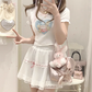 Front view of the white and pink Sweet Love Lace Bow Skort styled with a fitted graphic tee.