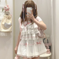 Model wearing the white and pink Sweet Love Lace Bow Skort styled with a matching top.
