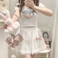 Model wearing the white and pink Sweet Love Lace Bow Skort styled with a plush bunny bag and casual top.