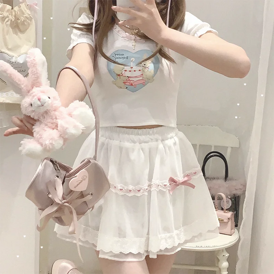 Model wearing the white and pink Sweet Love Lace Bow Skort styled with a plush bunny bag and casual top.