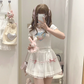 Model wearing the white and pink Sweet Love Lace Bow Skort styled with a graphic tee and plush bunny bag.
