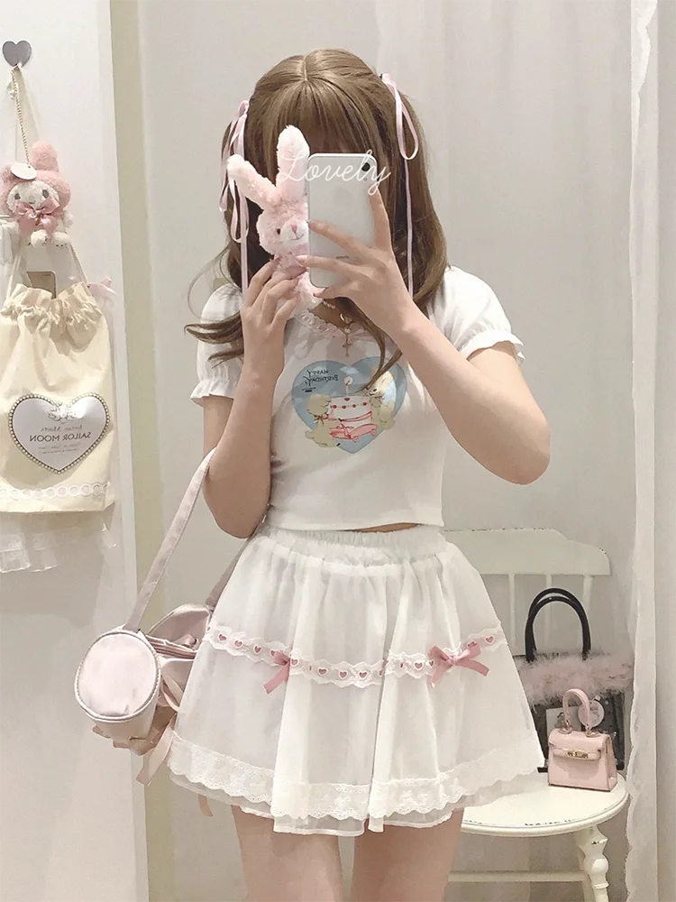 Mirror selfie of the white and pink Sweet Love Lace Bow Skort, showcasing the layered mesh and mini silhouette.