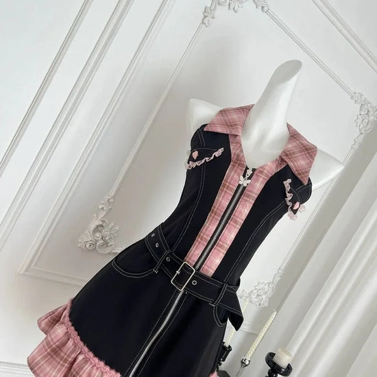 Angled front view of the Sweetheart Stitch Denim Dress in black denim with a pink plaid center panel.
