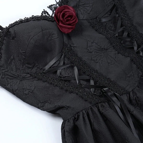 Close-up of the bodice on the Thorned Rose Corset Dress, showing rose appliqué, lace trim, and embossed butterfly print.