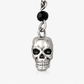Close-up detail of Til Death Do We Sparkle Earrings silver-plated skull charm, showing black bead accent and polished finish.