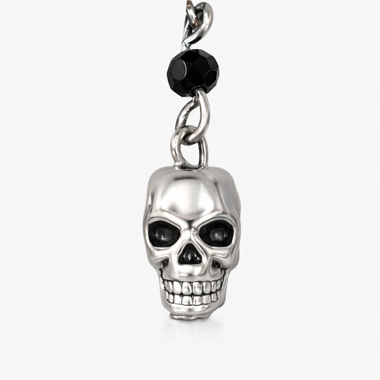 Close-up detail of Til Death Do We Sparkle Earrings silver-plated skull charm, showing black bead accent and polished finish.