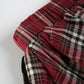 Detail shot of the side of the waistband of the Tilted Temper Tartan Skirt