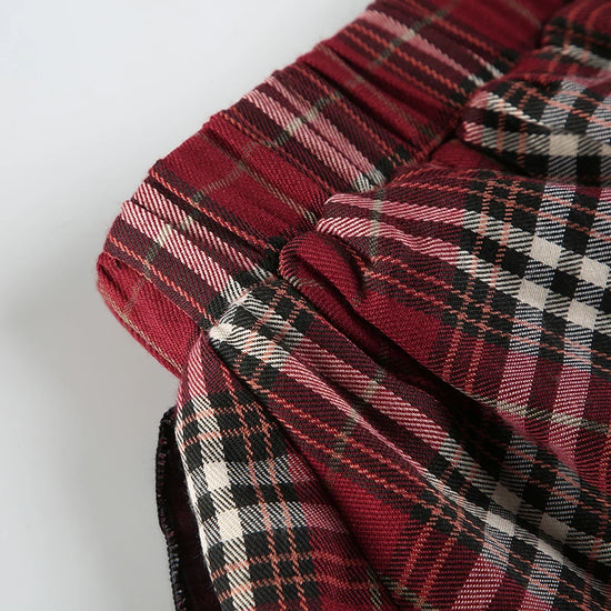 Detail shot of the side of the waistband of the Tilted Temper Tartan Skirt