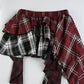 Detail shot of the front of the Tilted Temper Tartan Skirt. showing the details of the waistband and hem
