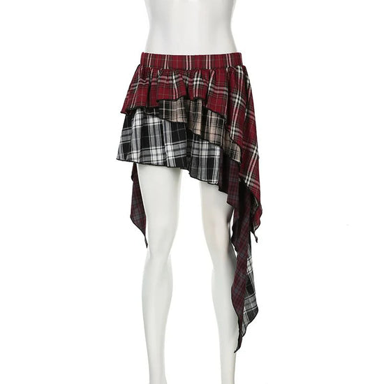 The frot of the Tilted Temper Tartan Skirt on a white mannequin, showcasing mismatched plaid panels and angled hem