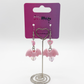 Two Moody Originals Candy Bite Bat Earrings blush pink version displayed on stand