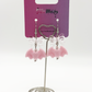 Two Moody Originals Candy Bite Bat Earrings with pastel pink bat charms, transparent pink acrylic bows, and pink glass bead accents on a Two Moody jewelry display.