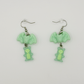 Two Moody Originals Candy Bite Bat Earrings in mint green with skeleton gummy charm